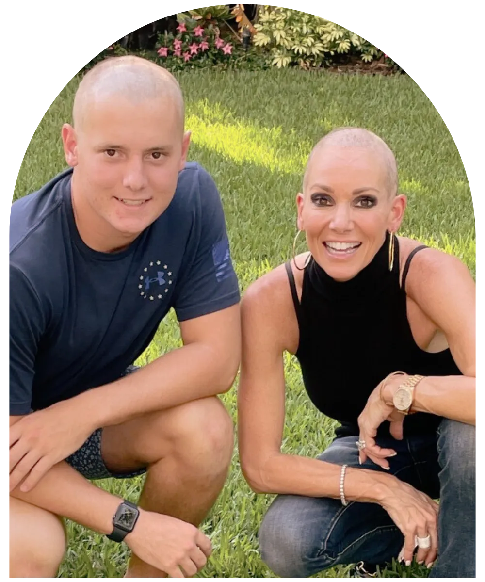 Tara Zuzga, founder of Laurie’s Love, smiling during treatment beside a young man on a lawn